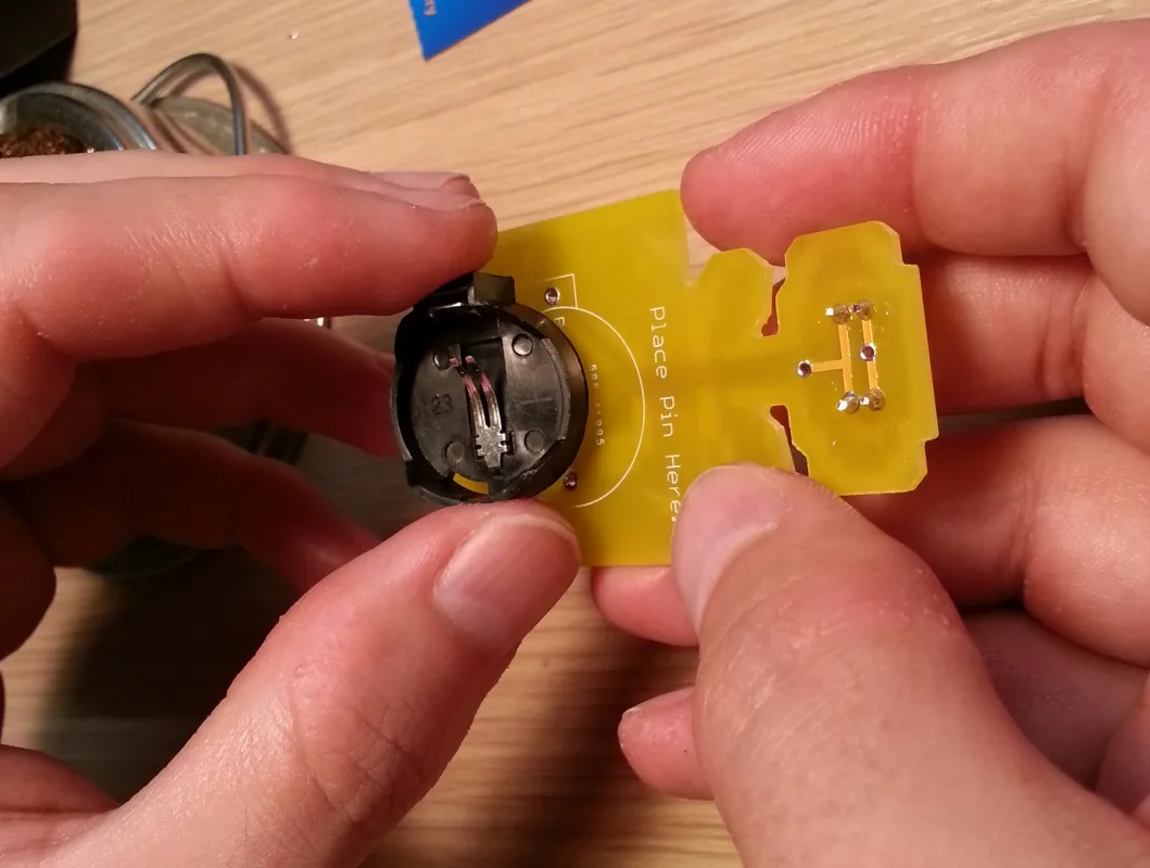 A beginner soldering kit — a light-up flower badge for events and workshops.