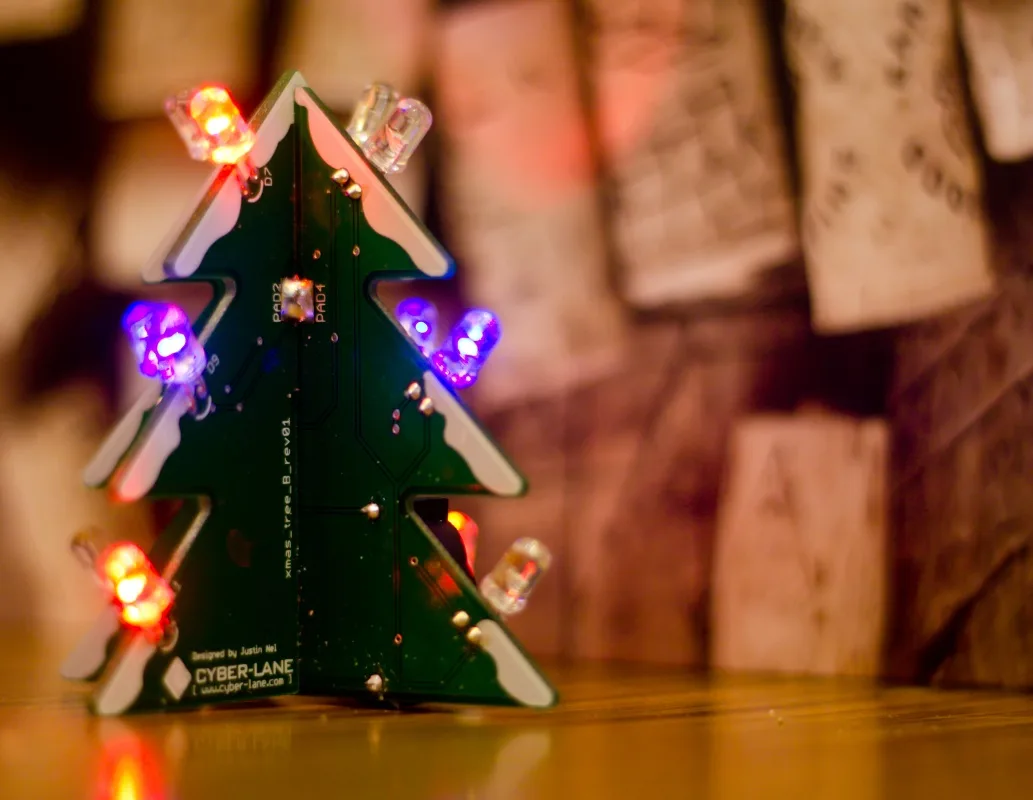 A light-up Christmas tree soldering kit with two interlocking PCBs.